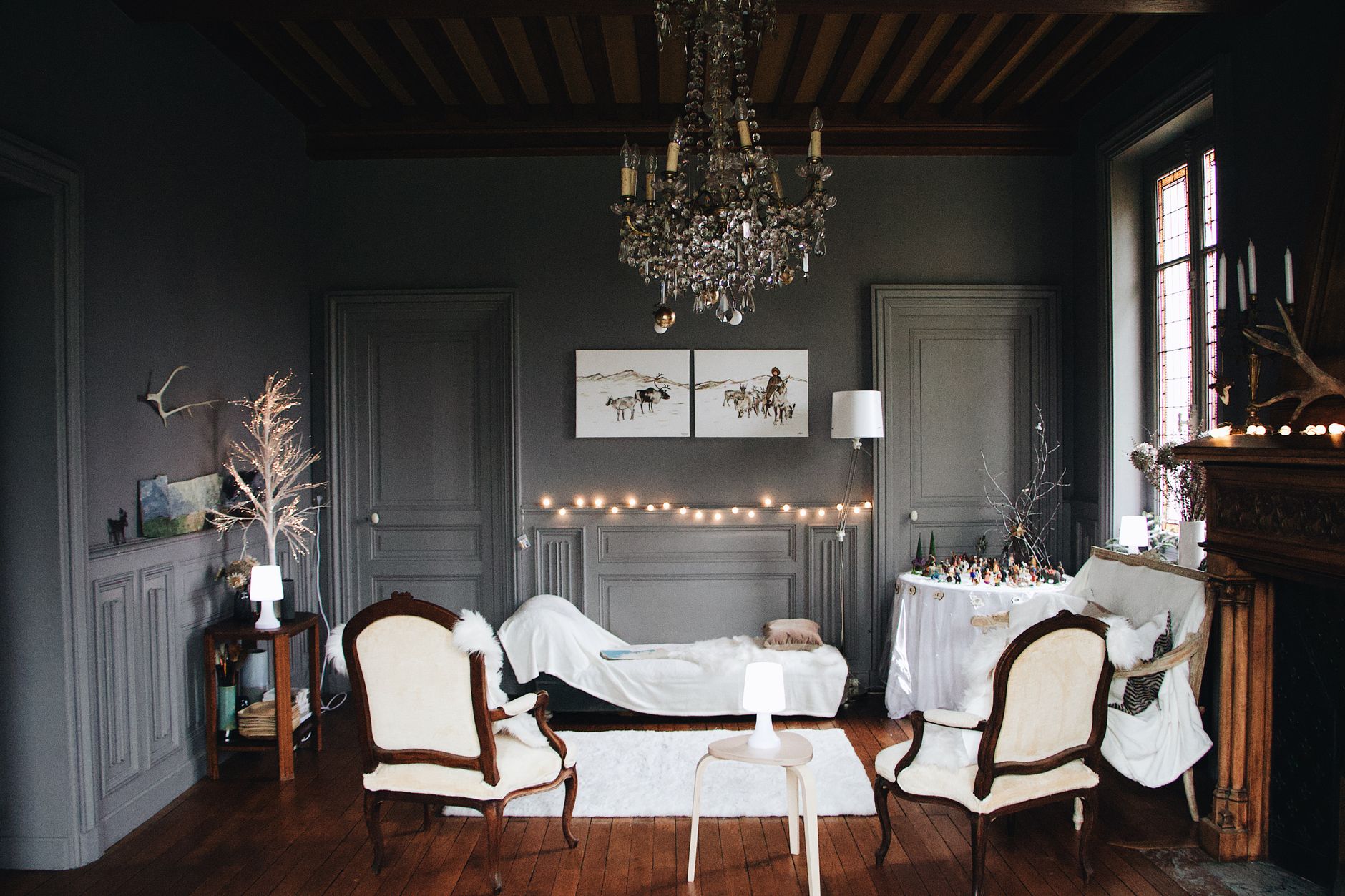 Cozy living room with classic decor and string lights creating a warm holiday ambiance.