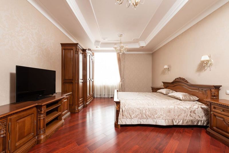 Luxurious classic bedroom with ornate furniture and natural lighting.