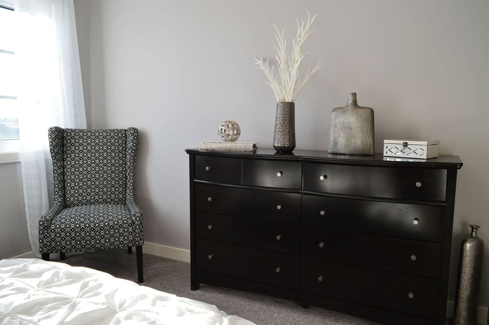 Sleek and stylish bedroom with modern black furniture and elegant decor.
