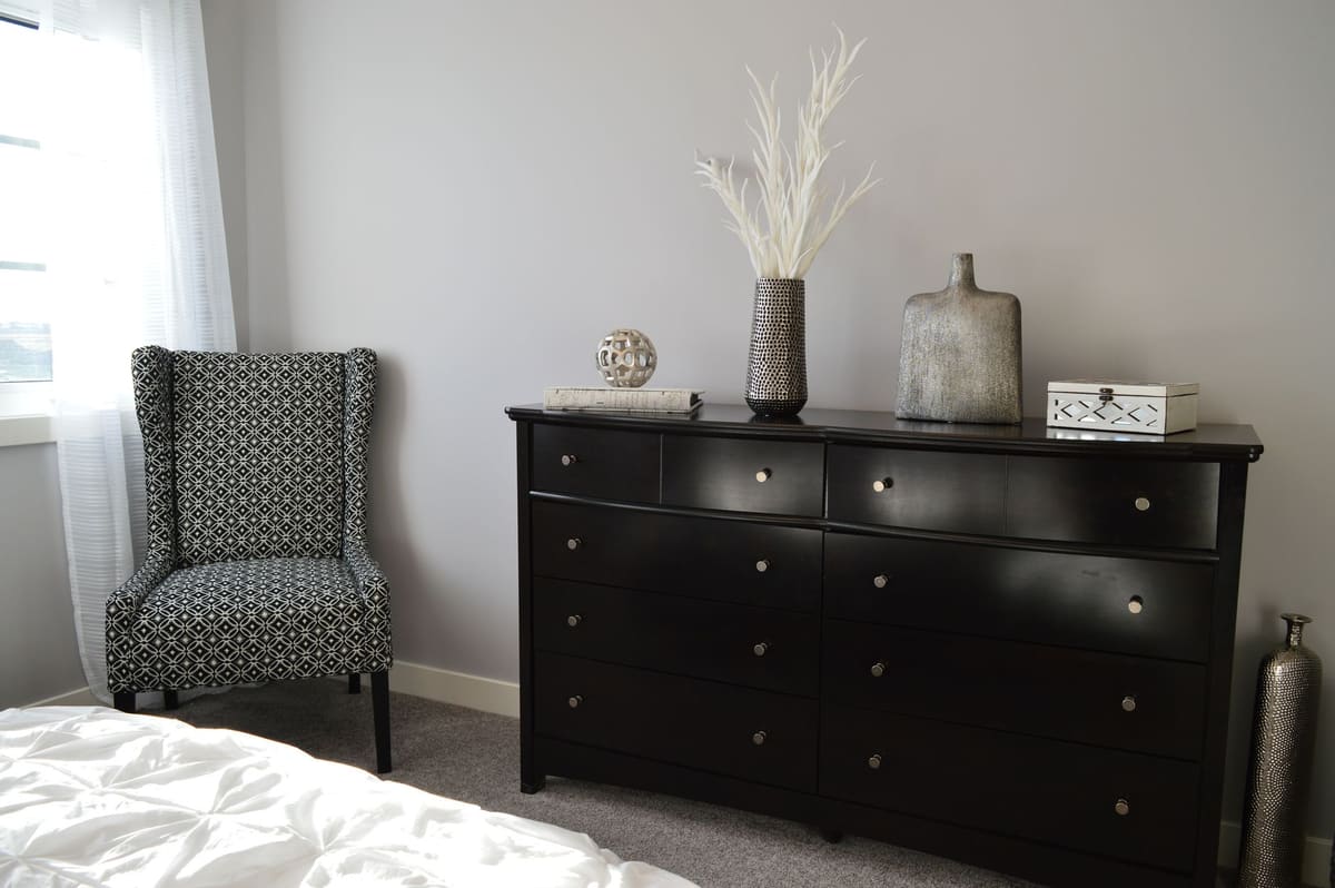 Sleek and stylish bedroom with modern black furniture and elegant decor.
