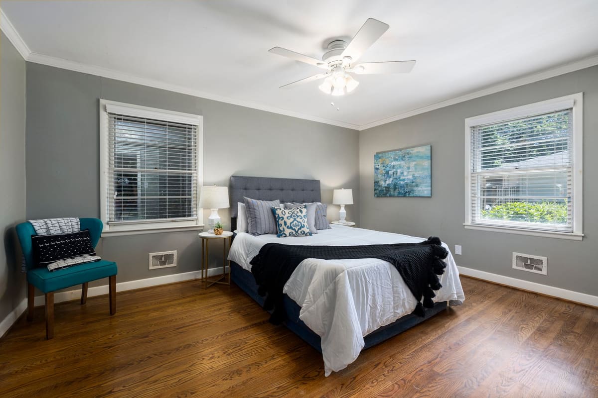 A tranquil and stylish bedroom featuring modern furnishings and natural light.