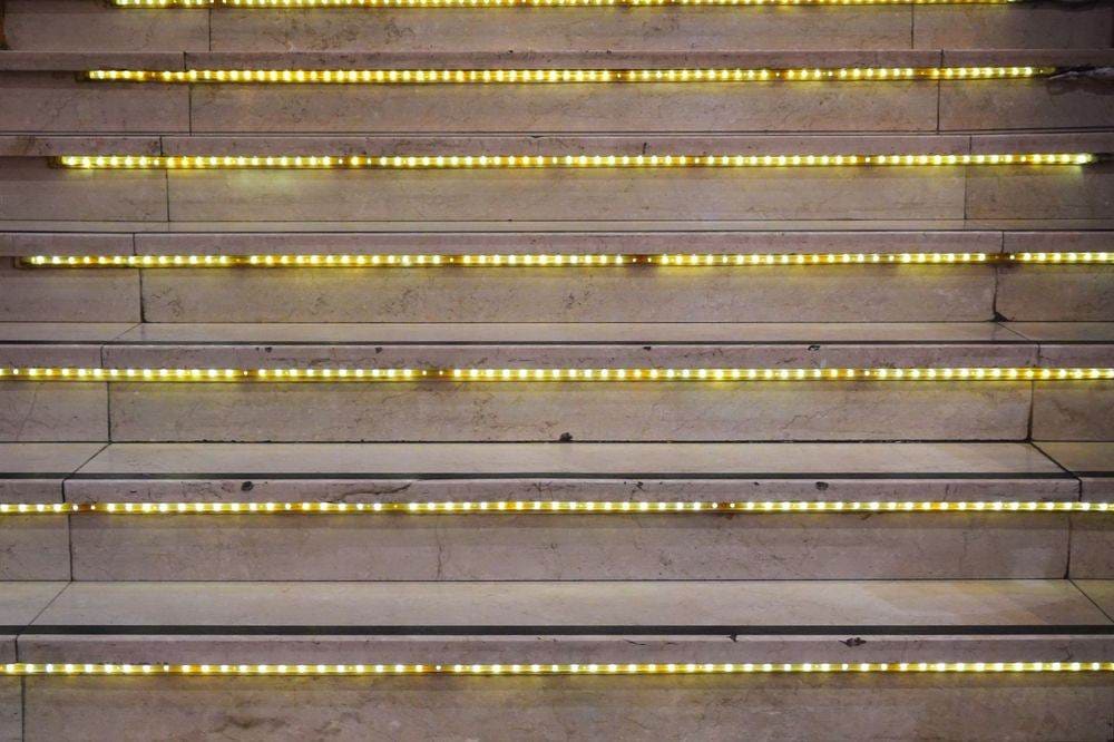 Close-up of a staircase with glowing LED lights on each step, creating a modern look.