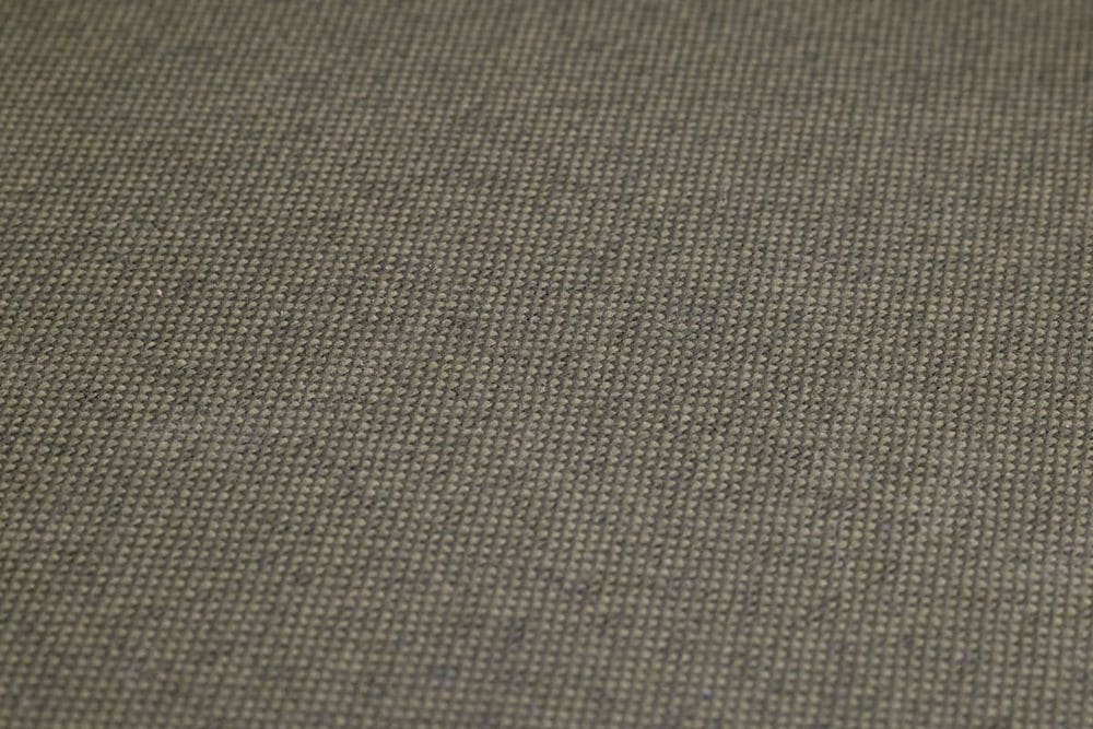 High-resolution close-up of olive green woven fabric, showcasing detailed texture and pattern.