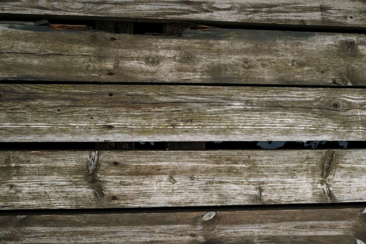 Close-up of rustic wooden planks with a natural texture, ideal for backgrounds.