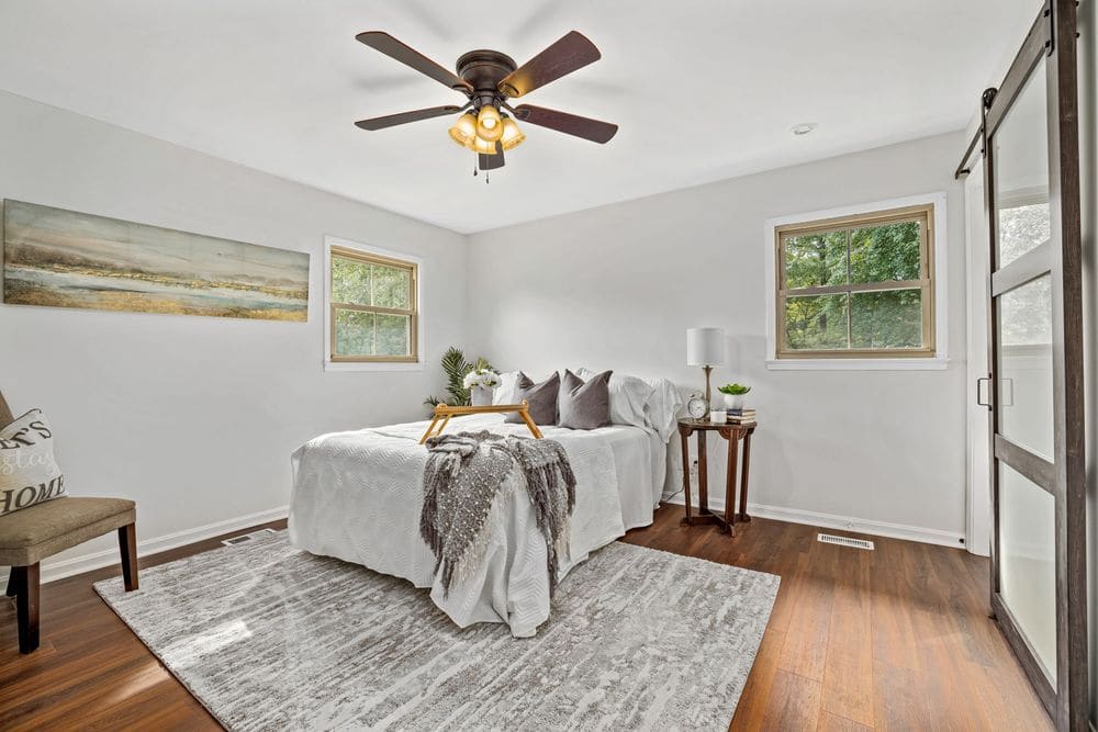 Tranquil modern bedroom with cozy white bedding and classic wood accents.