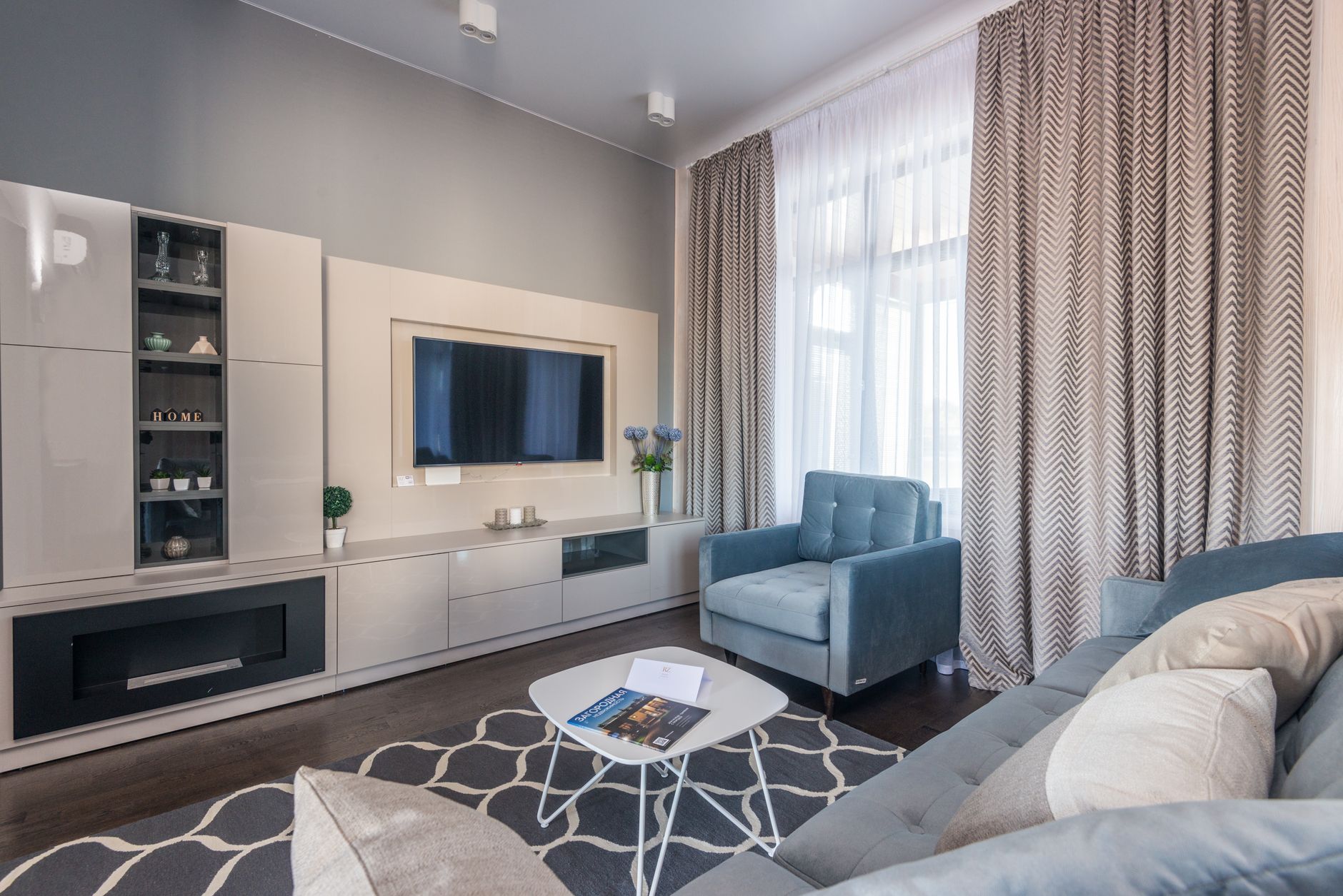 Stylish and modern living room with elegant furniture and decor, creating a cozy atmosphere.