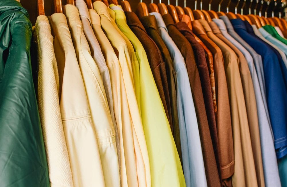 A vibrant selection of shirts and jackets in a wardrobe, perfect for fashion concepts.