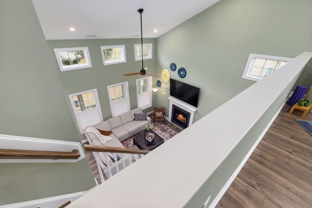 Bright modern living room interior with fireplace viewed from above. Elegant decor and natural light.