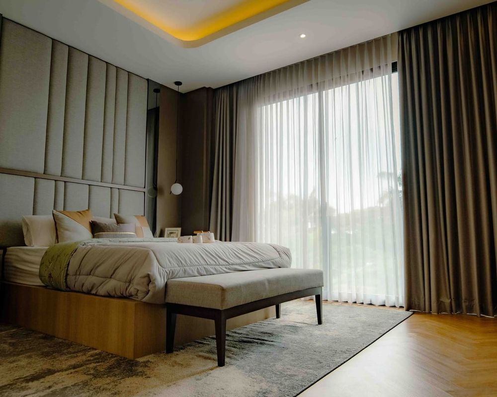 Contemporary bedroom in Jakarta with elegant design and abundant natural light.