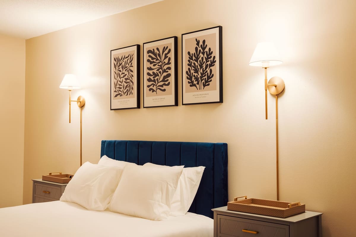 Stylish modern hotel room with elegant lighting and framed wall art.
