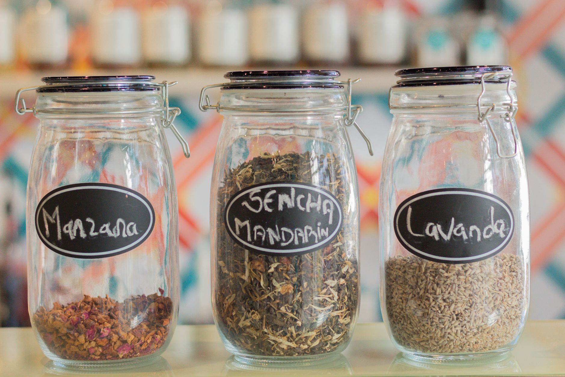 Three glass jars labeled with herbs and spices
