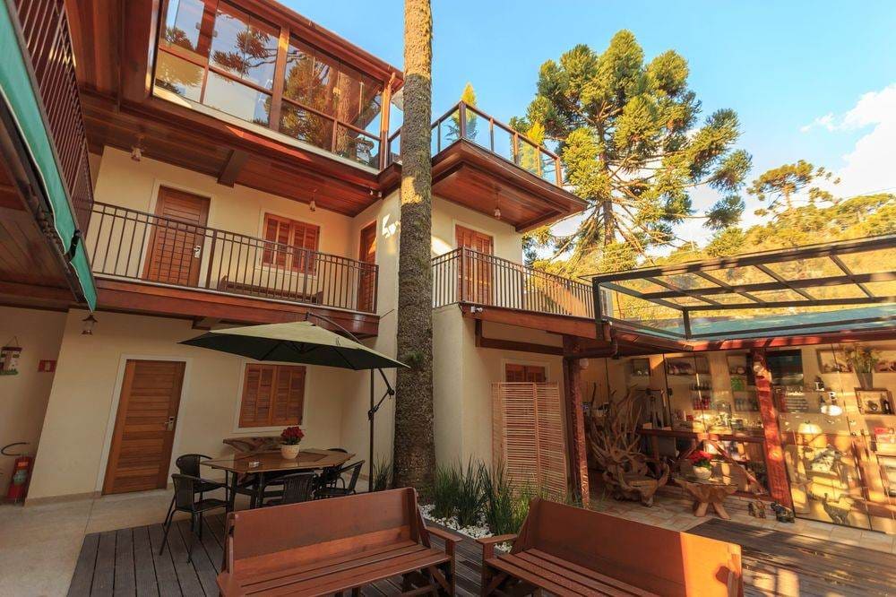 Rustic wooden terrace with modern outdoor seating and natural elements, perfect for relaxation.