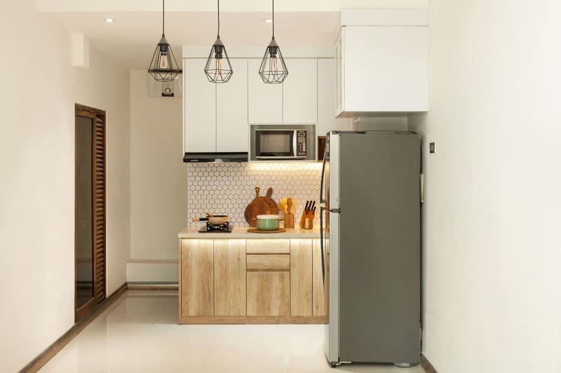 Stylish minimalist kitchen interior with wooden cabinets and sleek appliances.