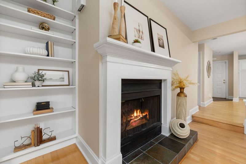 Elegant living room interior featuring a lit fireplace and decorative shelving.