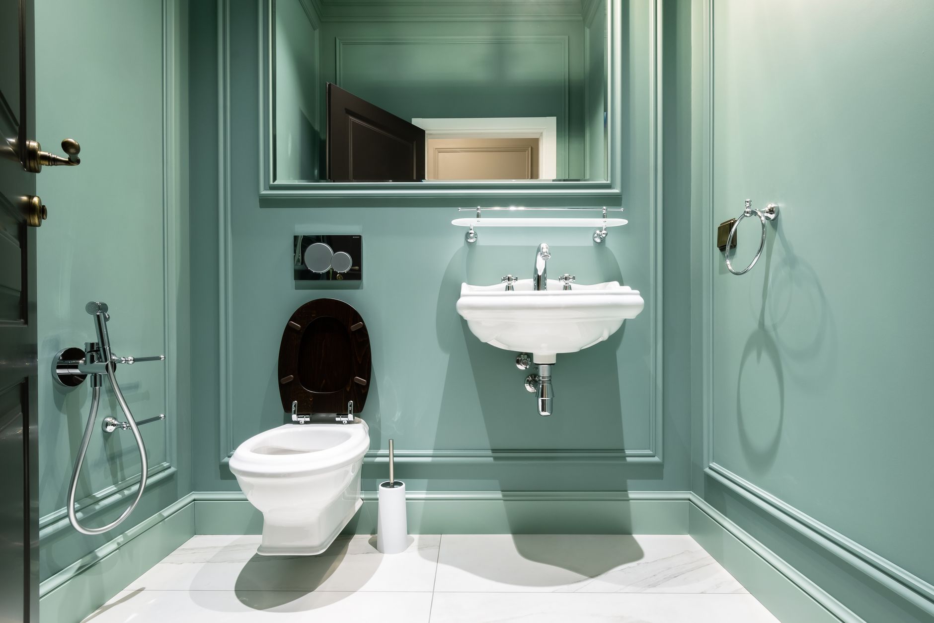 Stylish bathroom design featuring green walls, classic sink, and elegant fixtures in Saint Petersburg.